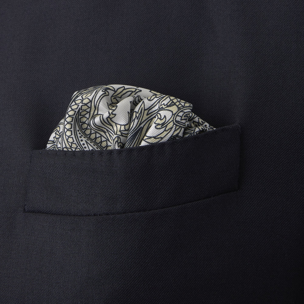 A White and Yellow House Paisley Silk Pocket Square by Turnbull & Asser, featuring an elegant house paisley pattern and the brand name printed in the bottom right corner.