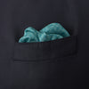 View 4 of product The Kingfisher Green Monocle Silk Pocket Square by Turnbull & Asser features an elegant geometric pattern and border, with the Turnbull & Asser name displayed in white on the lower right corner.
