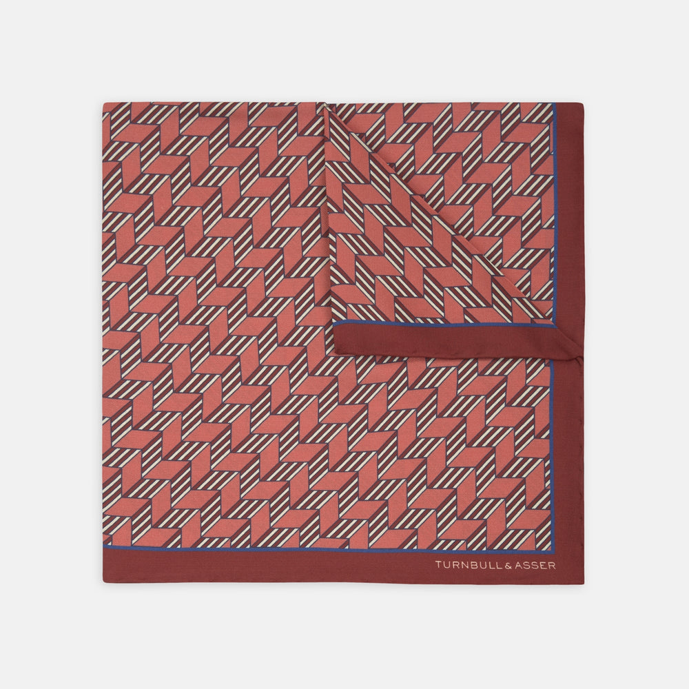 The Turnbull & Asser Red and Pink Arrow Silk Pocket Square features a striking pattern and luxurious silk, perfect for adding elegance to any look.