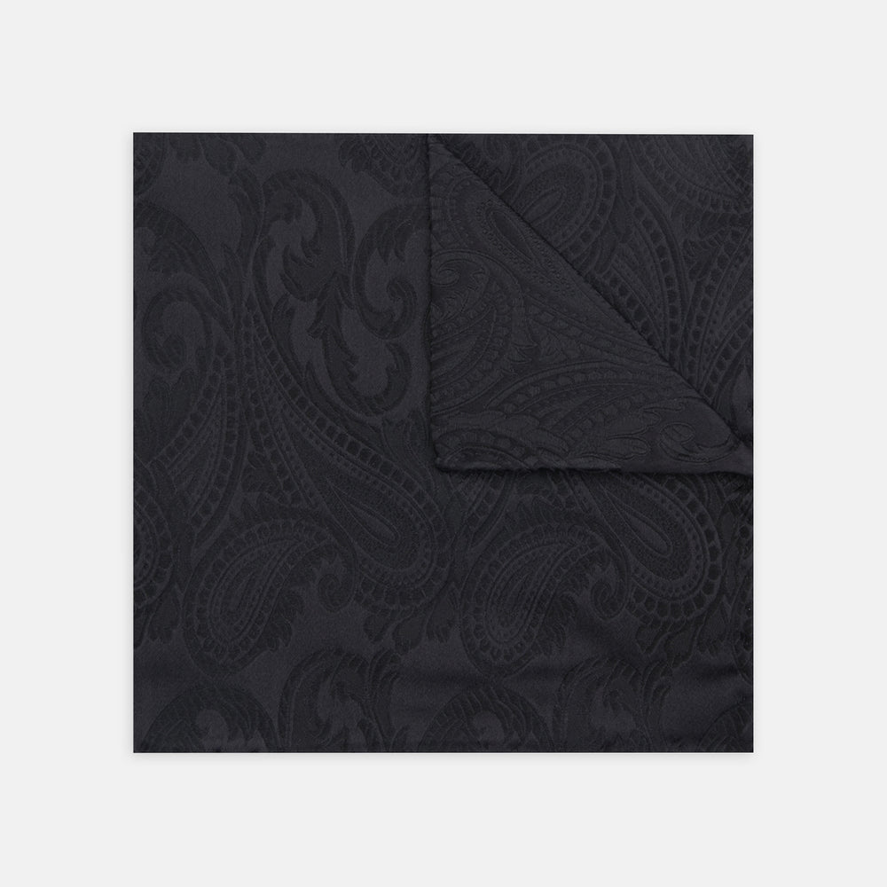 The Turnbull & Asser Black House Paisley Hand-Rolled Silk Pocket Square is elegantly folded to showcase both sides—a refined accessory, ideal for black tie attire.