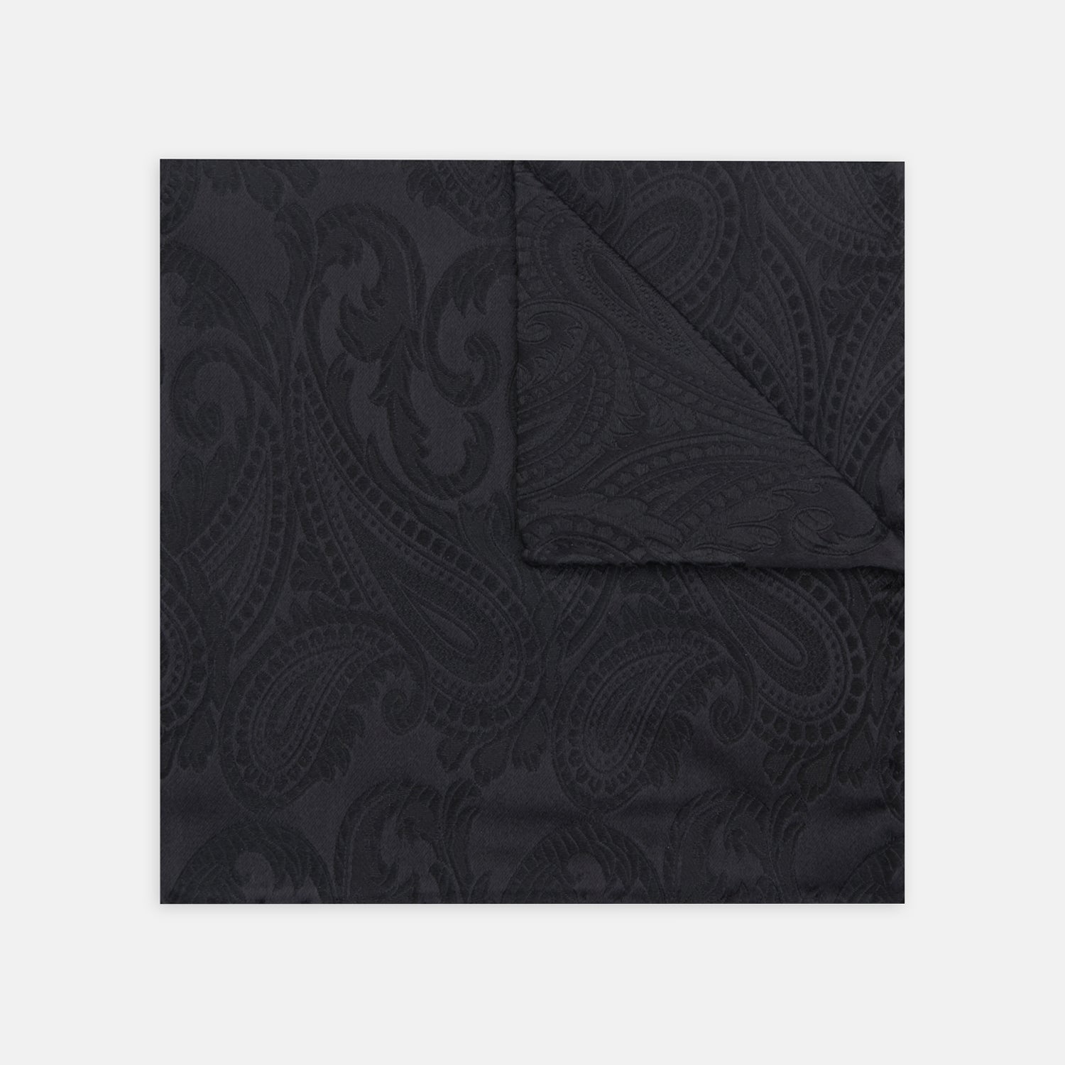 View 1 of product The Turnbull & Asser Black House Paisley Hand-Rolled Silk Pocket Square is elegantly folded to showcase both sides—a refined accessory, ideal for black tie attire.