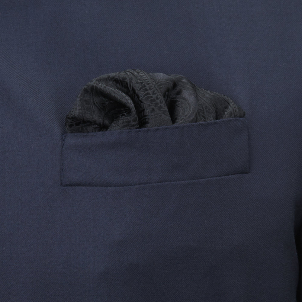 The Turnbull & Asser Black House Paisley Hand-Rolled Silk Pocket Square is elegantly folded to showcase both sides—a refined accessory, ideal for black tie attire.