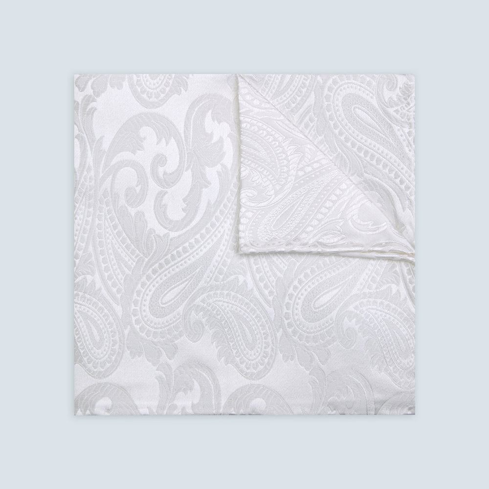 The Turnbull & Asser White House Paisley Hand-Rolled Silk Pocket Square is shown neatly folded to reveal both sides of its white woven fabric, ideal for black tie, set against a light gray background.