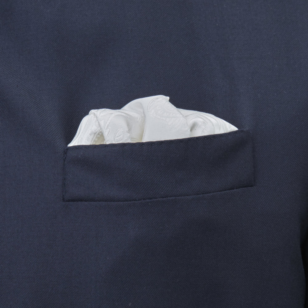 The Turnbull & Asser White House Paisley Hand-Rolled Silk Pocket Square is shown neatly folded to reveal both sides of its white woven fabric, ideal for black tie, set against a light gray background.