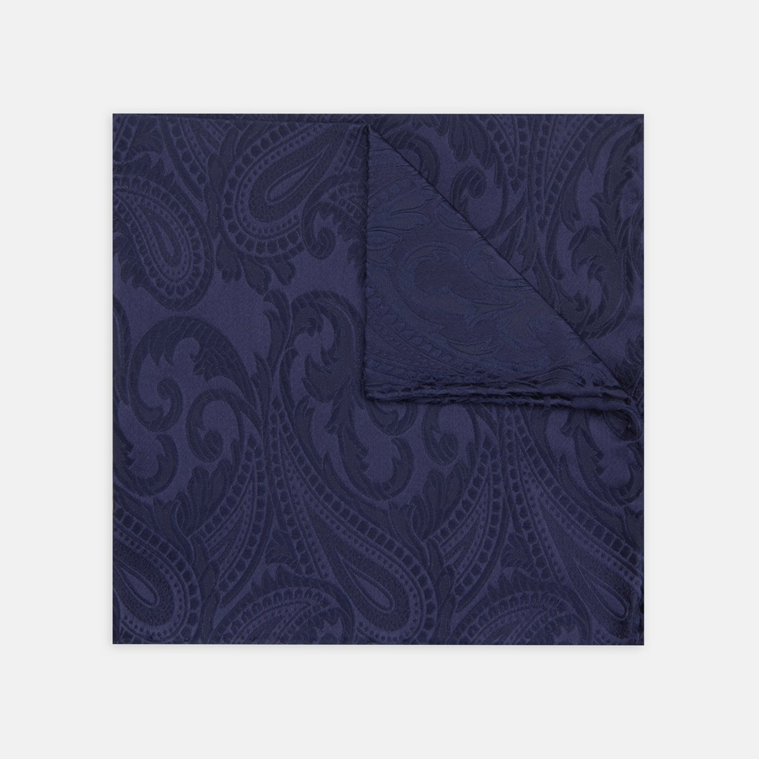 View 1 of product The Navy House Paisley Hand-Rolled Silk Pocket Square by Turnbull & Asser, shown folded to display its pattern against a white background, adds an elegant touch to black tie attire.