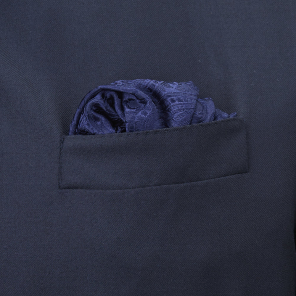The Navy House Paisley Hand-Rolled Silk Pocket Square by Turnbull & Asser, shown folded to display its pattern against a white background, adds an elegant touch to black tie attire.