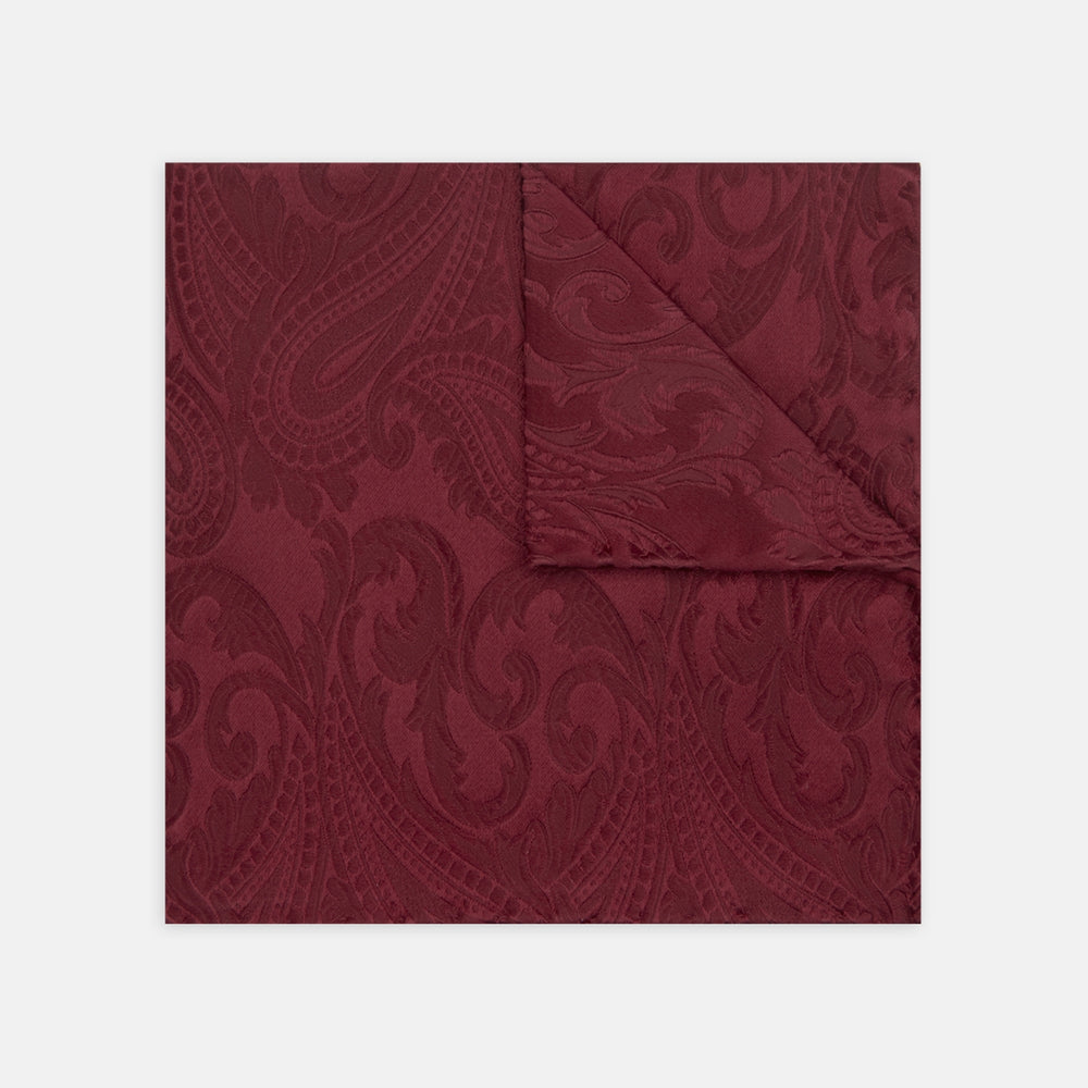 The Turnbull & Asser Burgundy House Paisley Hand-Rolled Silk Pocket Square features elegant paisley silk, expertly hand-rolled edges, and a classic fold—ideal for elevating black tie attire.