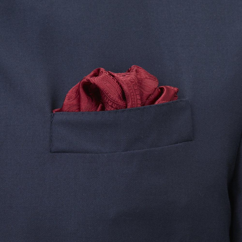The Turnbull & Asser Burgundy House Paisley Hand-Rolled Silk Pocket Square features elegant paisley silk, expertly hand-rolled edges, and a classic fold—ideal for elevating black tie attire.