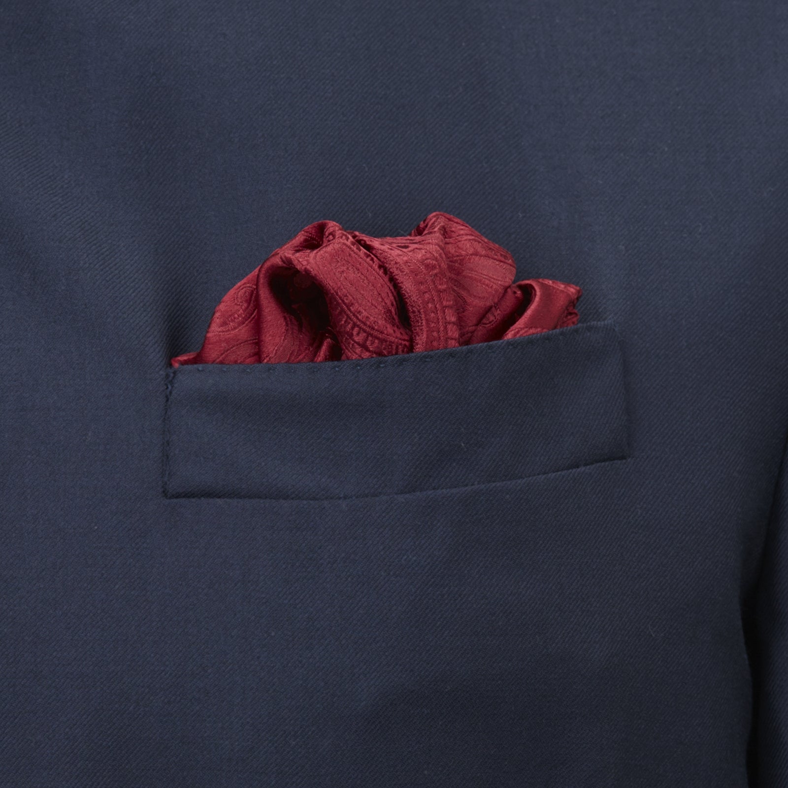 View 4 of product The Turnbull & Asser Burgundy House Paisley Hand-Rolled Silk Pocket Square features elegant paisley silk, expertly hand-rolled edges, and a classic fold—ideal for elevating black tie attire.