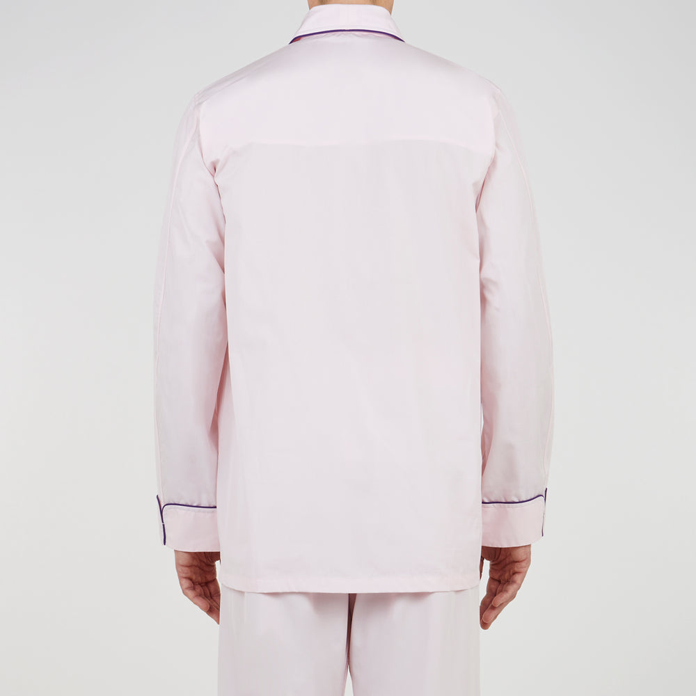 The Turnbull & Asser Pink Piped Cotton Pyjama Set, featuring dark piping on the collar and front with matching pants, is elegantly displayed on a white background—a luxurious sleepwear choice.