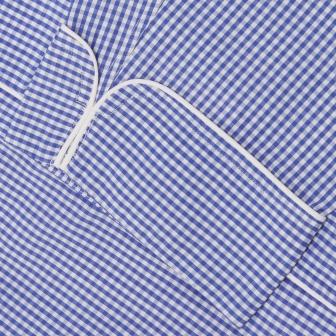 View 4 of product The Turnbull & Asser Mid Blue Gingham Check Piped Cotton Pyjama Set features white piping, two buttons, and a matching fabric belt, displayed on a white background—ideal for lovers of classic luxury sleepwear.