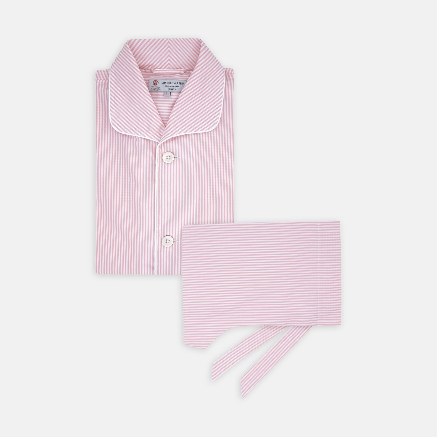 View 1 of product The Turnbull & Asser Pink Bengal Stripe Piped Cotton Pyjama Set features a folded pink and white striped top with white buttons and a matching fabric belt, both displayed flat on a light background.