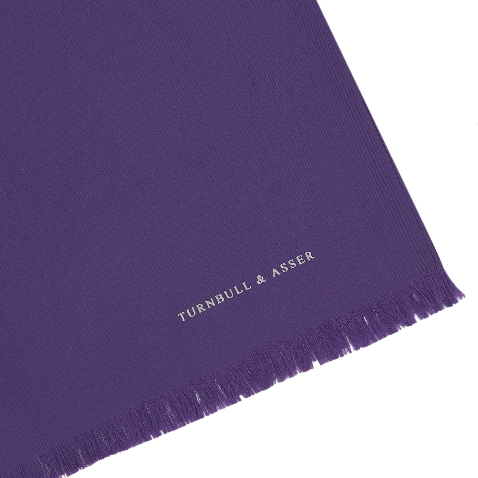 View 2 of product A long, elegant Plain Purple Silk Scarf by Turnbull & Asser, crafted from silk with fringed ends and neatly folded, makes a stylish accessory for any wardrobe.