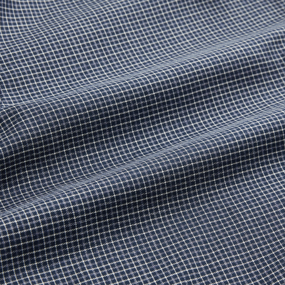 A man in a tie wears the Turnbull & Asser Navy Check Regular Fit Flannel Shirt with T&A collar and 3 button cuffs.