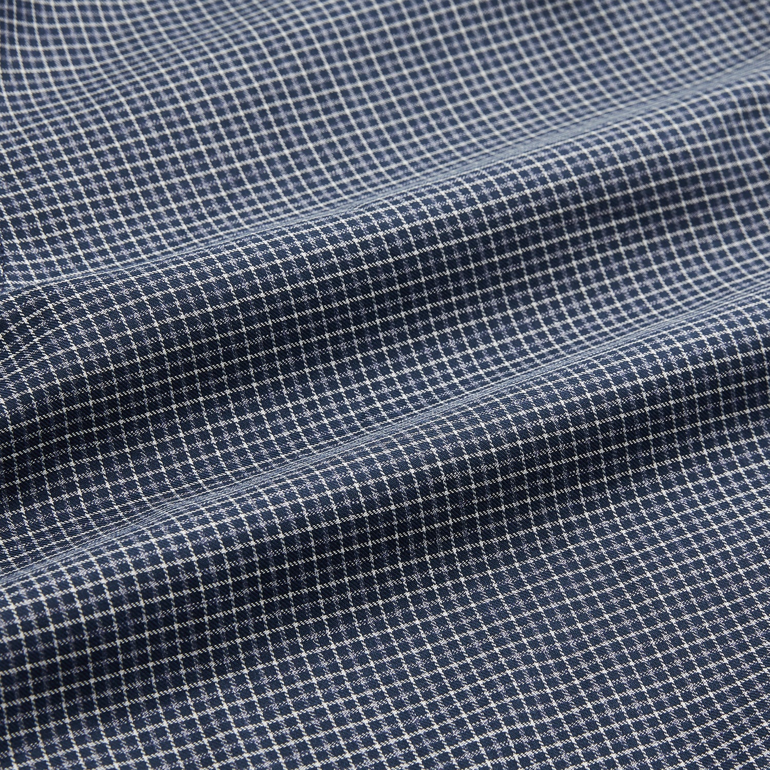 View 6 of product A man in a tie wears the Turnbull & Asser Navy Check Regular Fit Flannel Shirt with T&A collar and 3 button cuffs.