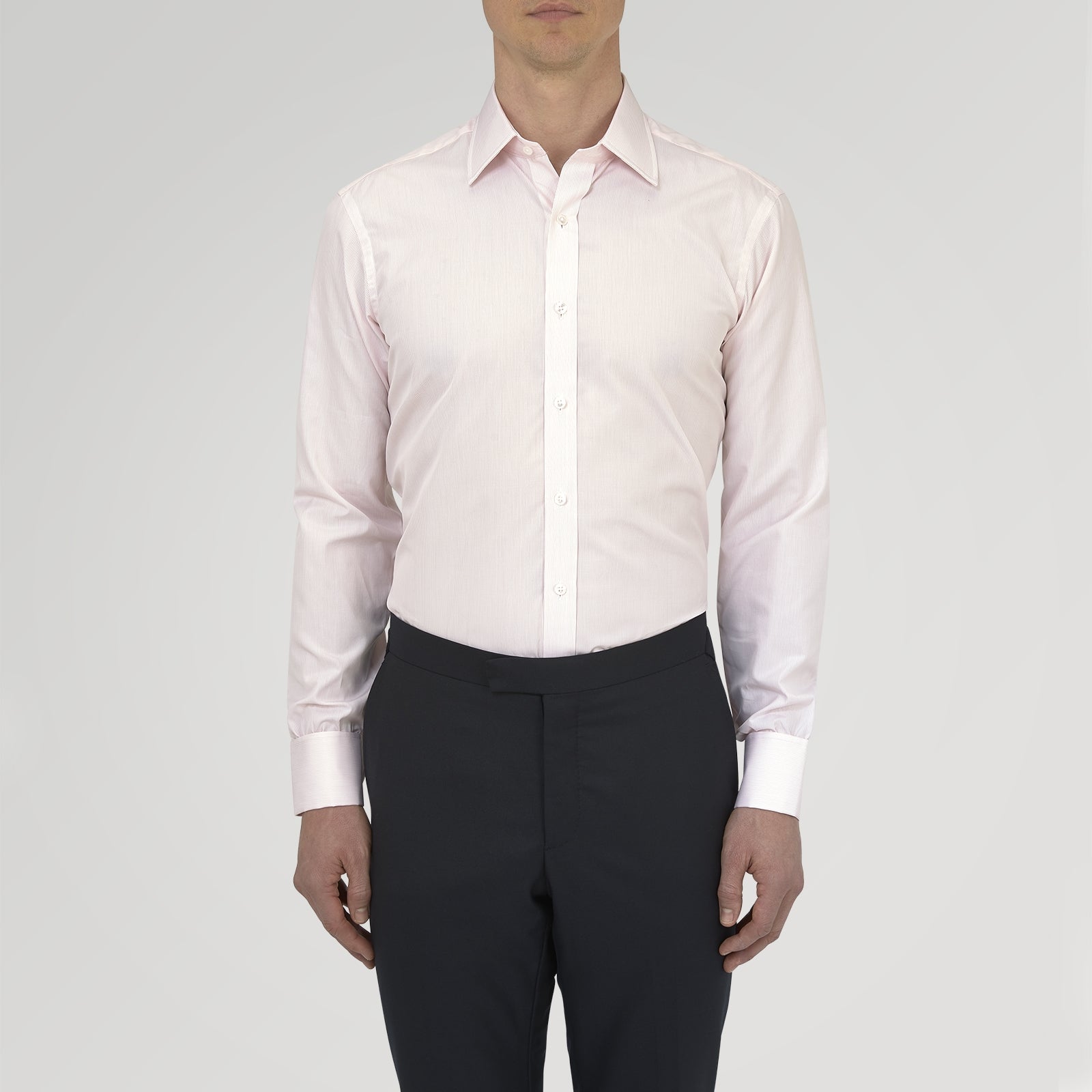 View 2 of product The Turnbull & Asser Pink Hairline Stripe Cotton Shirt features a T&A collar, double cuffs, neat vertical stripes, white buttons, and a chest pocket—perfect for the office. Shown neatly folded on a plain white background.