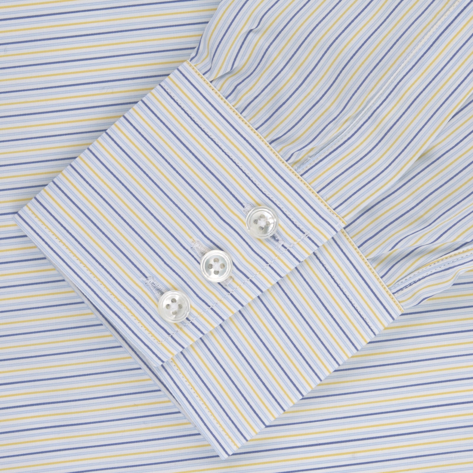 View 2 of product The Turnbull & Asser Yellow and Navy Small Stripe Shirt features a T&A collar, 3-button cuffs, and vertical stripes, laid flat on a white background.
