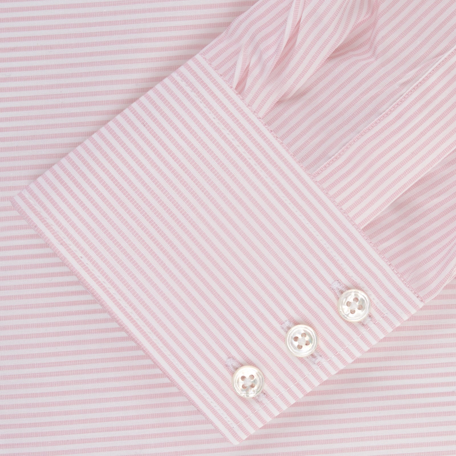View 2 of product The Turnbull & Asser Pink and White Stripe Shirt features a POW collar and 3-button cuffs, displayed laid flat on a white background.
