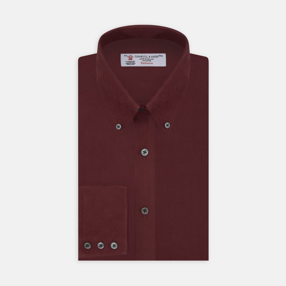 A Turnbull & Asser Burgundy Corduroy Cotton Shirt with a Cambridge collar and 3-button cuffs, neatly folded and displayed on a plain white background.