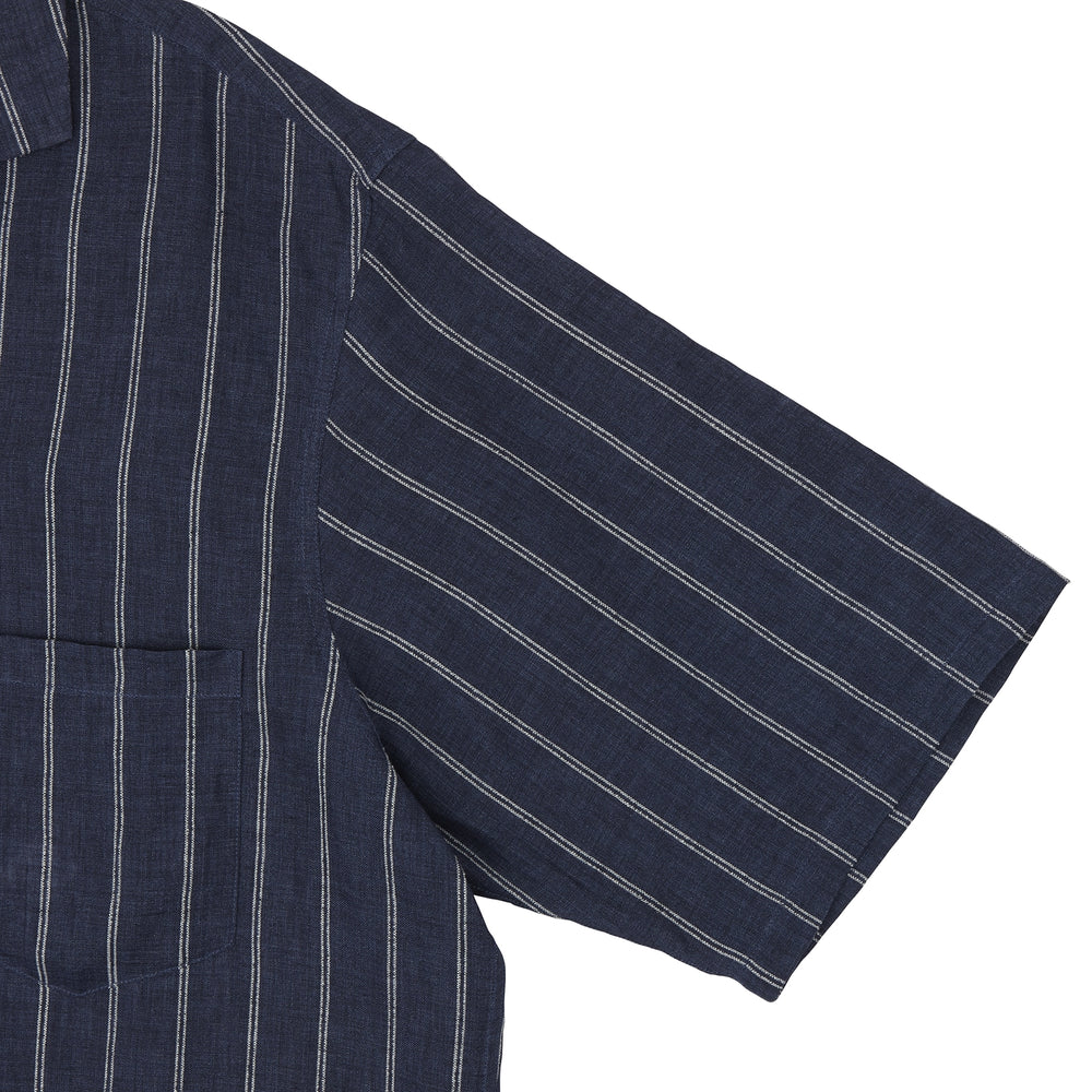 The Turnbull & Asser Holiday Fit Stripe Linen Short Sleeve Shirt features a navy background with vertical white stripes, a revere collar, and white buttons.