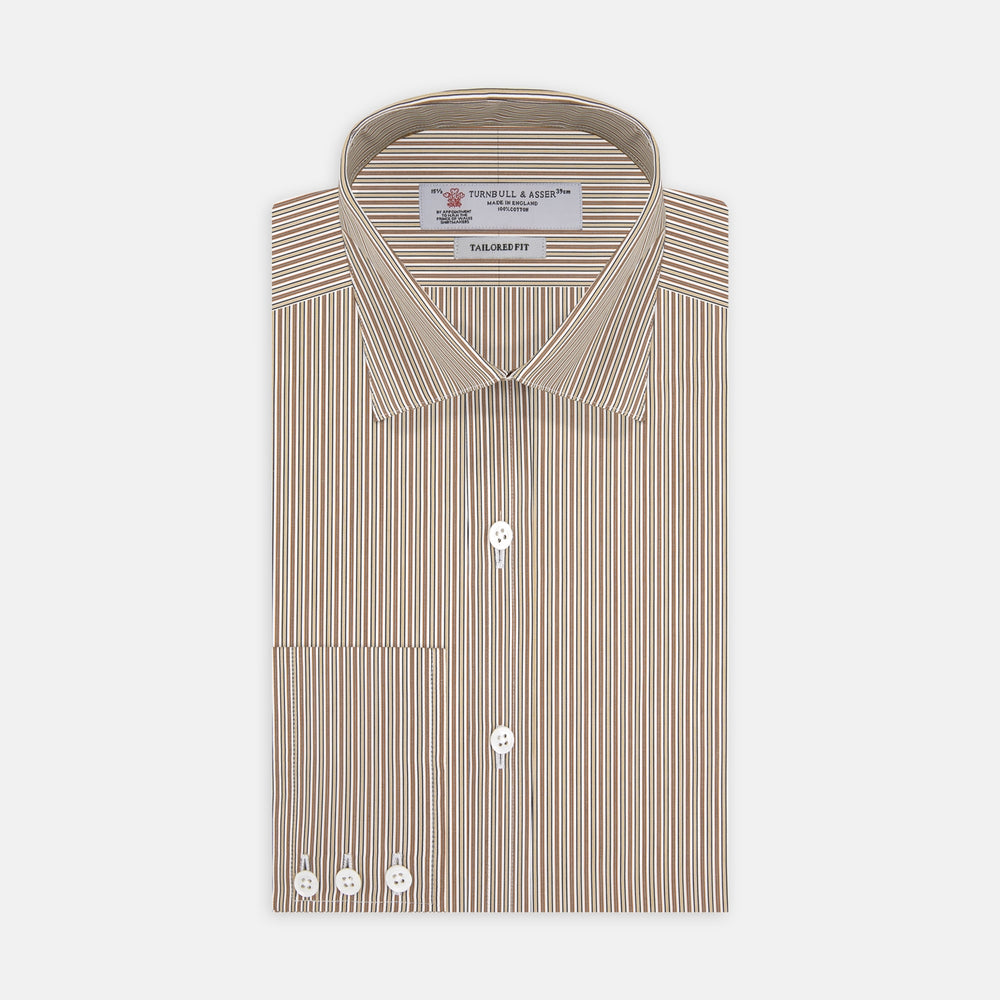 The Turnbull & Asser Tailored Fit Brown Fine Stripe Shirt features a Bury collar, 3-button cuffs, white buttons, and fine brown and white stripes. Made from premium Thomas Mason cotton and shown neatly folded on a plain white background.
