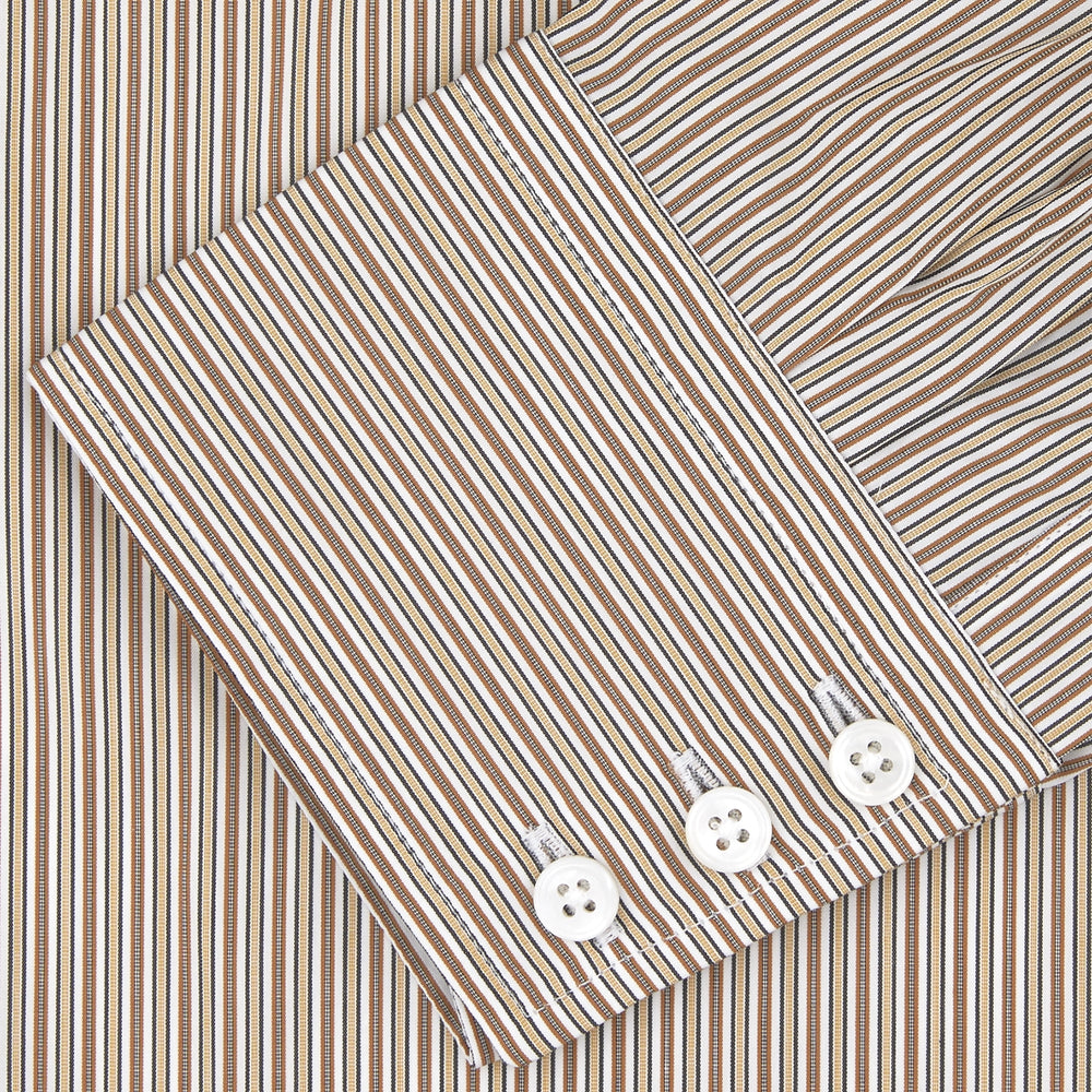 The Turnbull & Asser Tailored Fit Brown Fine Stripe Shirt features a Bury collar, 3-button cuffs, white buttons, and fine brown and white stripes. Made from premium Thomas Mason cotton and shown neatly folded on a plain white background.