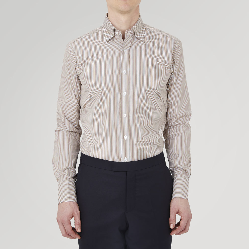 The Turnbull & Asser Tailored Fit Brown Fine Stripe Shirt features a Bury collar, 3-button cuffs, white buttons, and fine brown and white stripes. Made from premium Thomas Mason cotton and shown neatly folded on a plain white background.