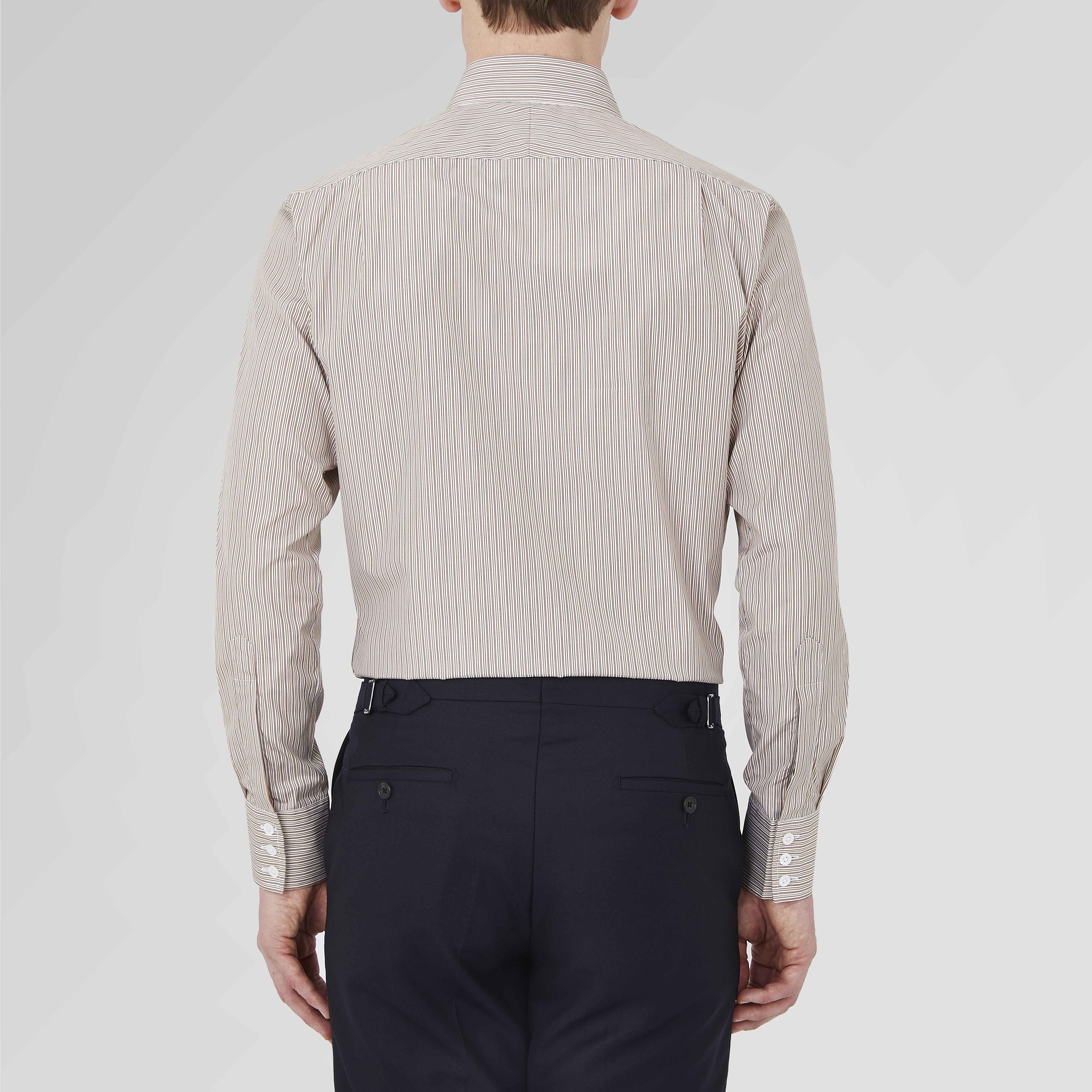View 3 of product The Turnbull & Asser Tailored Fit Brown Fine Stripe Shirt features a Bury collar, 3-button cuffs, white buttons, and fine brown and white stripes. Made from premium Thomas Mason cotton and shown neatly folded on a plain white background.