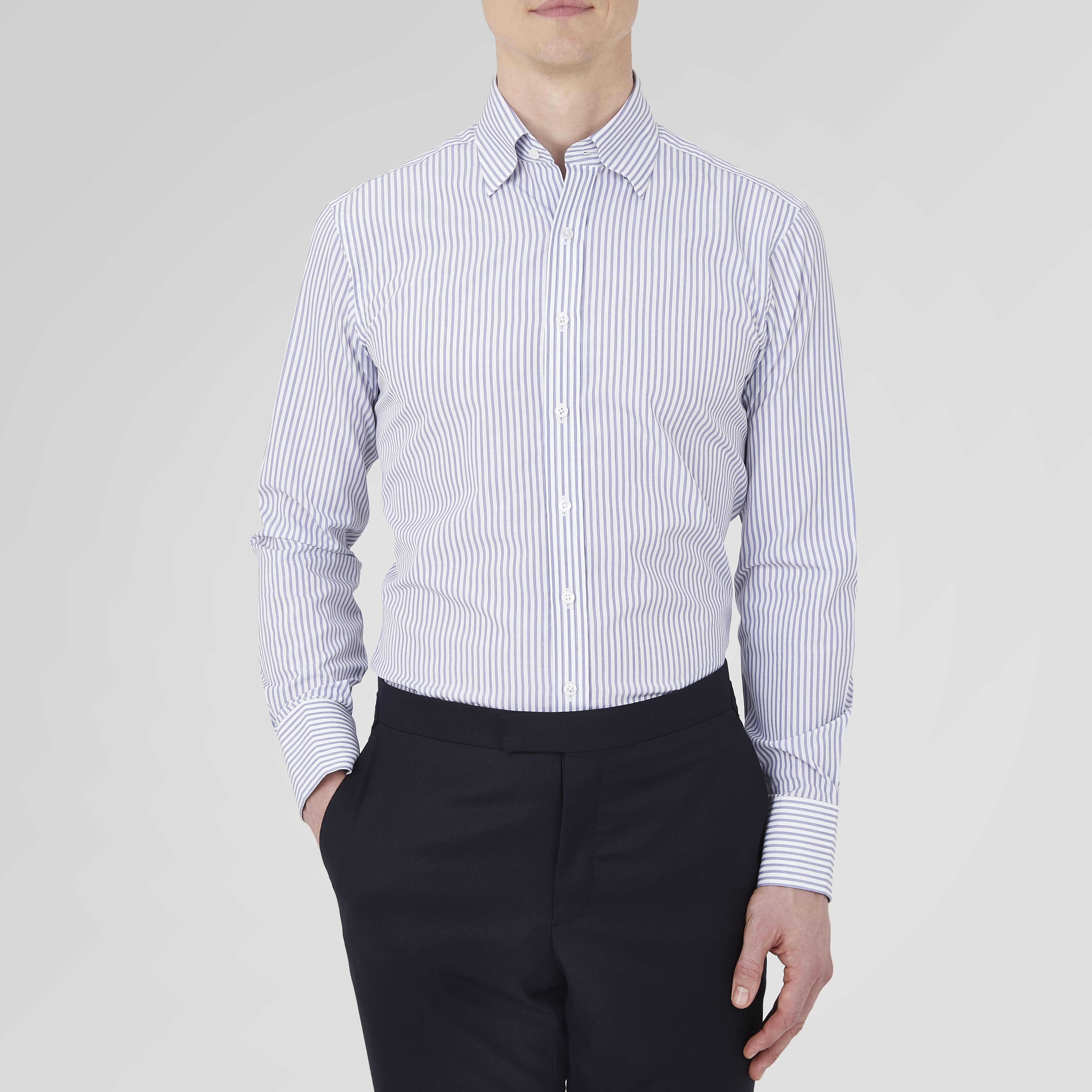 View 2 of product The Turnbull & Asser Tailored Fit Blue and White Stripe Sea Island Quality Cotton Shirt features a Bury collar and 3-button cuffs, neatly folded with white buttons, shown on a plain white background.