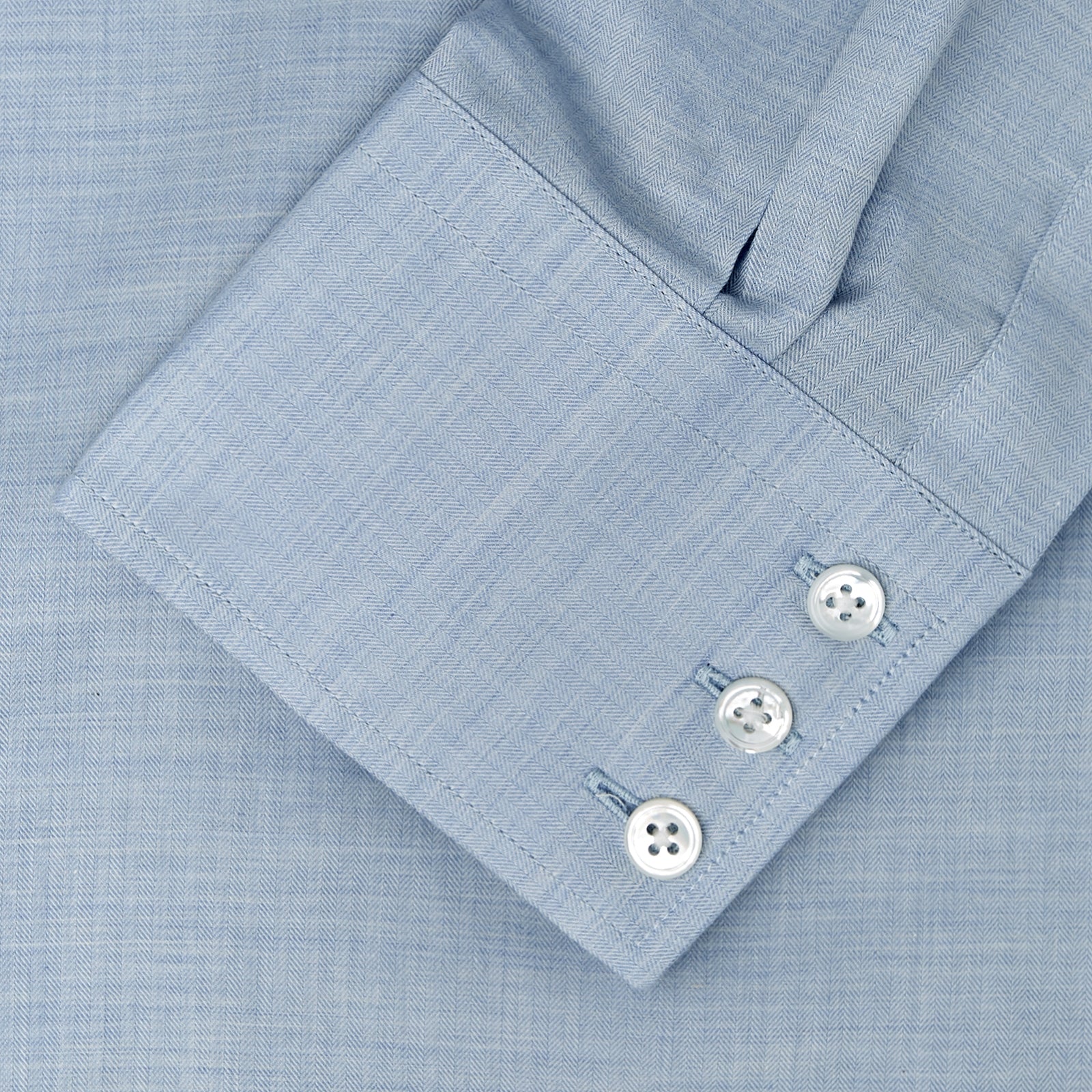 View 5 of product A neatly folded Tailored Fit Light Blue Flannel Shirt by Turnbull & Asser with a Bury collar and 3-button cuffs, displayed on a plain white background, features an inner collar label.