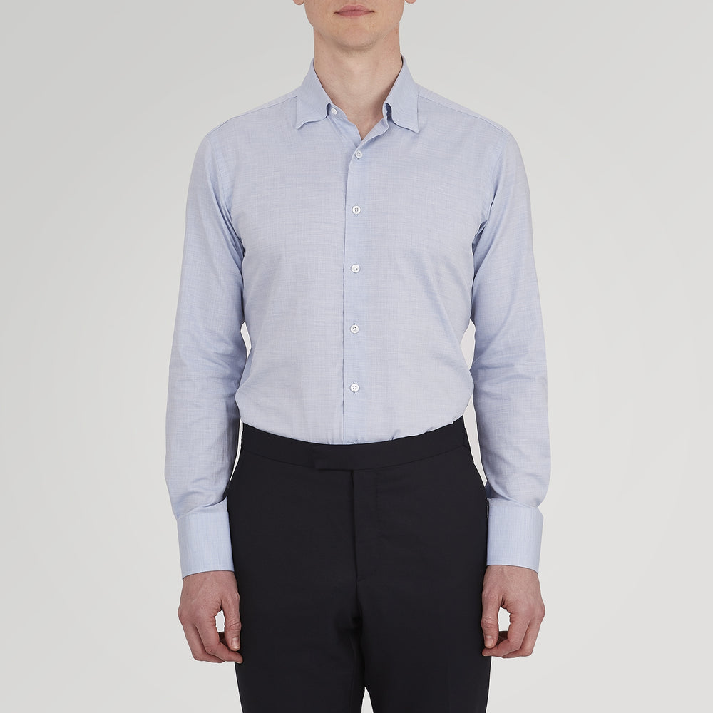 A neatly folded Tailored Fit Light Blue Flannel Shirt by Turnbull & Asser with a Bury collar and 3-button cuffs, displayed on a plain white background, features an inner collar label.