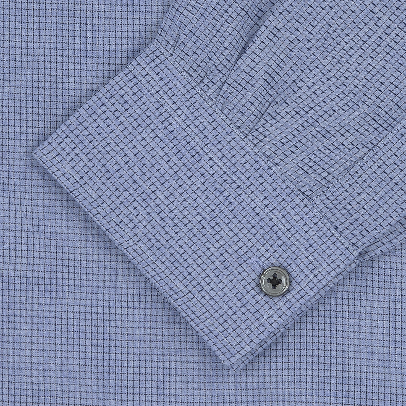 View 4 of product The Turnbull & Asser Weekend Fit Blue Cashmerello Light Shirt features a Dorset collar, 1-button cuffs, subtle check pattern, front pocket, and white buttons—softly folded on a white background.