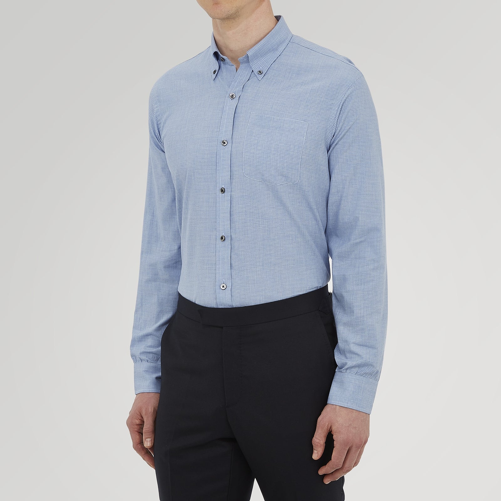 View 2 of product The Turnbull & Asser Weekend Fit Blue Cashmerello Light Shirt features a Dorset collar, 1-button cuffs, subtle check pattern, front pocket, and white buttons—softly folded on a white background.