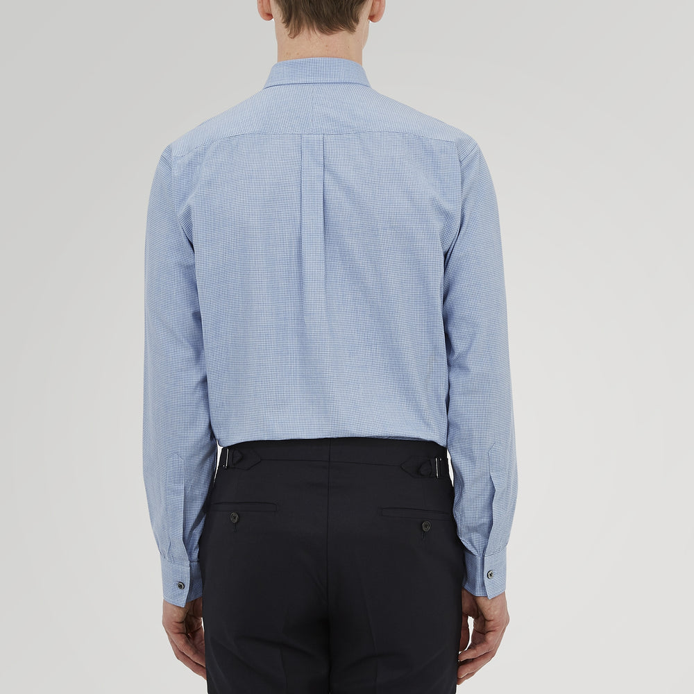 The Turnbull & Asser Weekend Fit Blue Cashmerello Light Shirt features a Dorset collar, 1-button cuffs, subtle check pattern, front pocket, and white buttons—softly folded on a white background.
