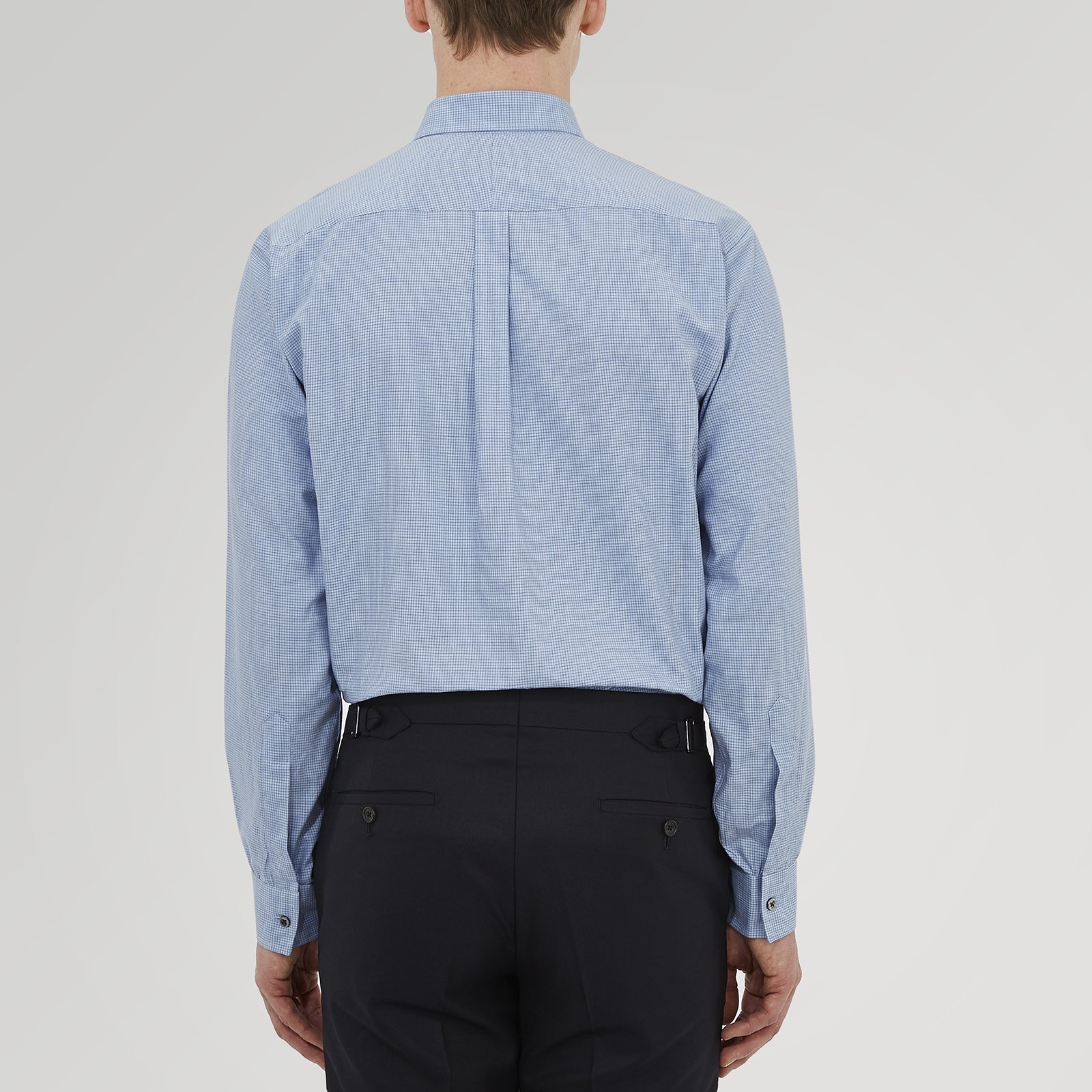 View 3 of product The Turnbull & Asser Weekend Fit Blue Cashmerello Light Shirt features a Dorset collar, 1-button cuffs, subtle check pattern, front pocket, and white buttons—softly folded on a white background.