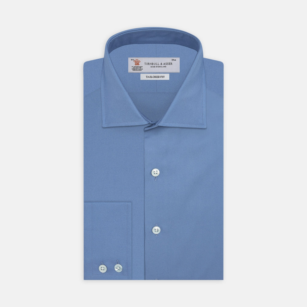 The Turnbull & Asser Tailored Fit Deep Blue Cotton Shirt features a classic Kent collar and 2-button cuffs, shown neatly folded with white buttons against a plain white background.