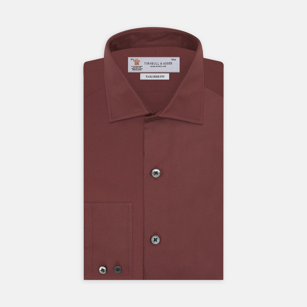 The Turnbull & Asser Tailored Fit Burgundy Cotton Shirt features a classic Kent collar and 2-button cuffs, displayed neatly folded with dark buttons against a plain white background.