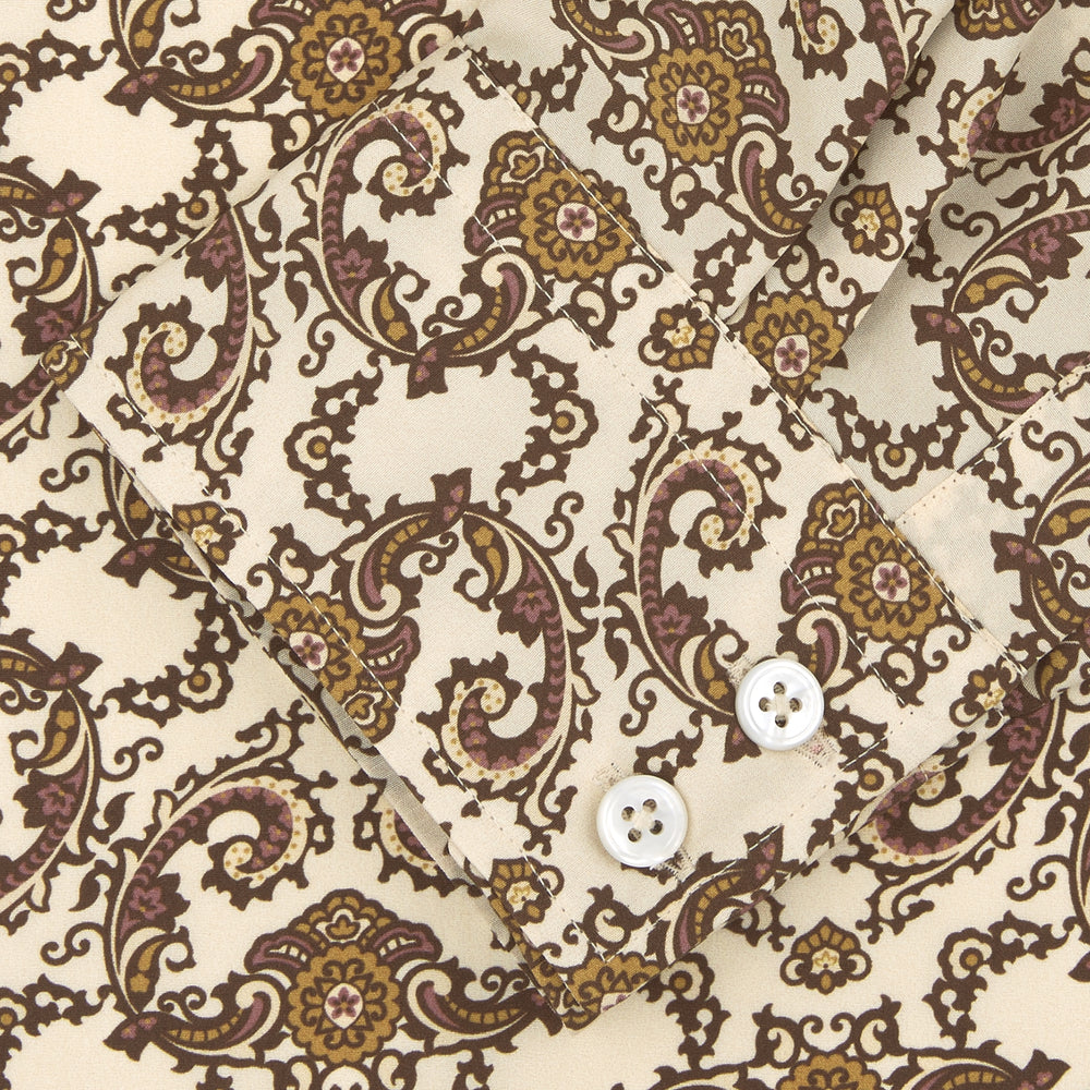 The Turnbull & Asser Tailored Fit Cream Jagger Print Silk Shirt features a Kent collar, 2-button cuffs, and an intricate brown and gold print on cream silk for timeless elegance.