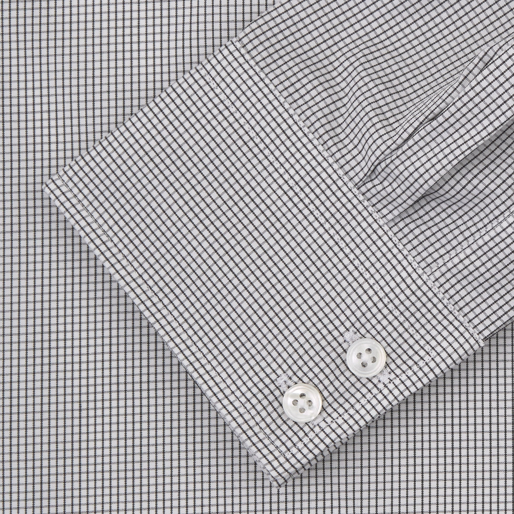 A neatly folded Turnbull & Asser Tailored Fit Grey and White Small Check Shirt with a Kent collar and 2-button cuffs is shown, featuring its brand label inside the collar.