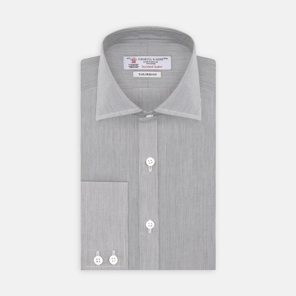 Turnbull & Asser’s Tailored Fit Grey End-On-End Shirt features a classic Kent collar, white buttons, and 2-button cuffs. This long-sleeved shirt is displayed neatly folded against a plain white background.