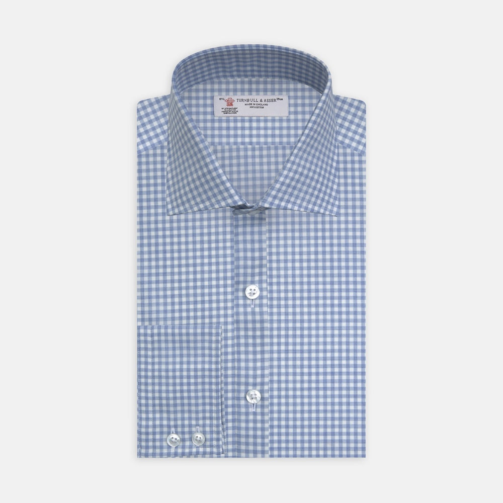 A circular swatch of Turnbull & Asser's Light Blue Gingham Cotton Fabric, featuring a blue and white checkered pattern with a thin gray border, displayed against a plain light background.