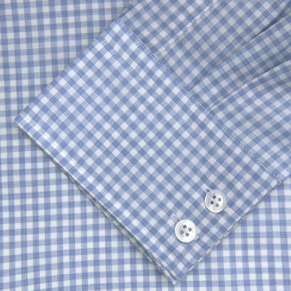 The Turnbull & Asser Tailored Fit Light Blue Gingham Shirt features a Kent collar, 2-button cuffs, and a small blue-and-white checkered pattern, shown on a white background.