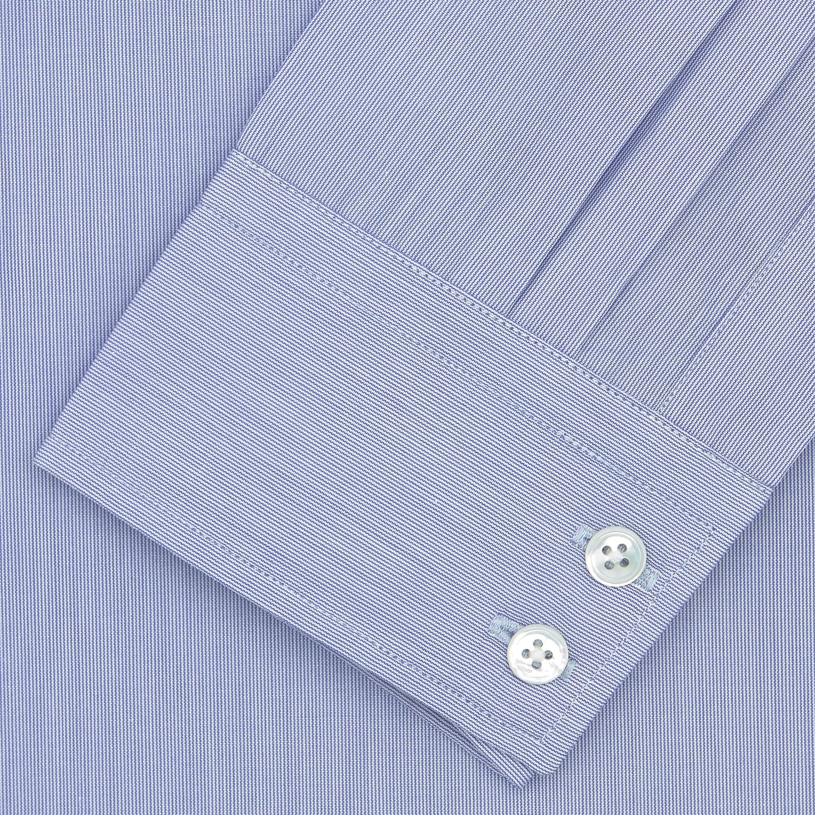 View 2 of product A neatly folded Turnbull & Asser Blue Hairline Stripe Tailored Fit Shirt with a Kent collar and double cuffs is displayed on a plain white background, with the brand label visible inside the collar.