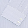 View 2 of product The Turnbull & Asser Tailored Fit Blue and White Fine Stripe Shirt features a Kent collar and 2-button cuffs, shown neatly folded against a plain white background.