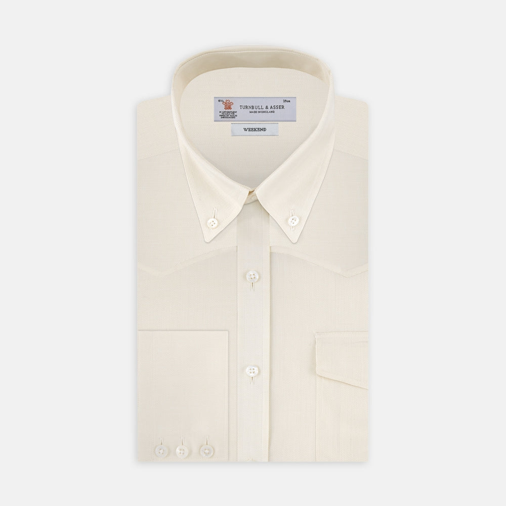The Turnbull & Asser Weekend Fit Cream Herringbone Western Shirt features a Norfolk collar, button cuffs, and chest pockets, elegantly folded and displayed on a plain white background.