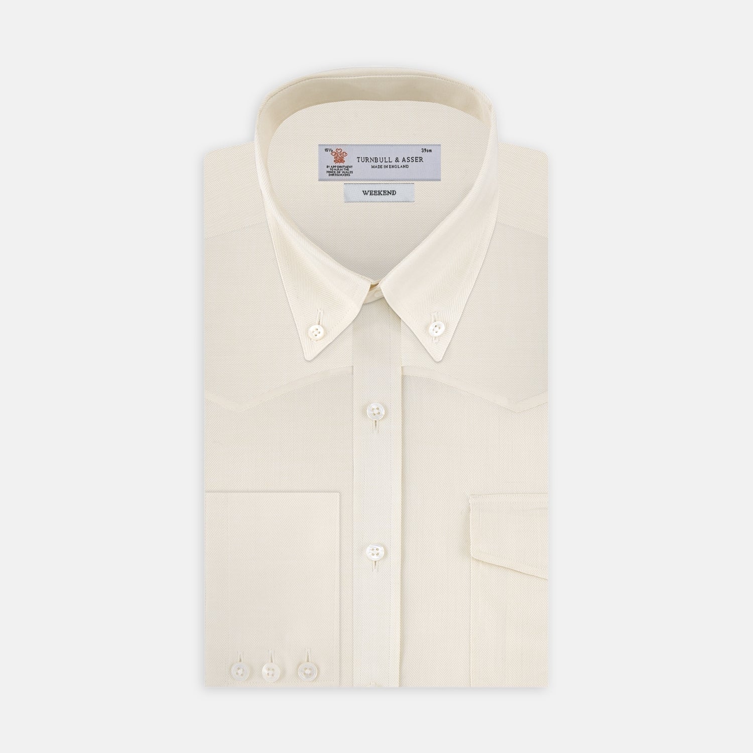 View 1 of product The Turnbull & Asser Weekend Fit Cream Herringbone Western Shirt features a Norfolk collar, button cuffs, and chest pockets, elegantly folded and displayed on a plain white background.