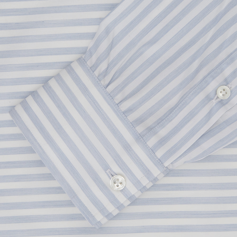 The Turnbull & Asser Weekend Fit Blue Stripe Cotton Shirt with Dorset collar and 1-button cuffs is laid flat on a white background, showcasing its classic long sleeves, striped design, and button-down front.