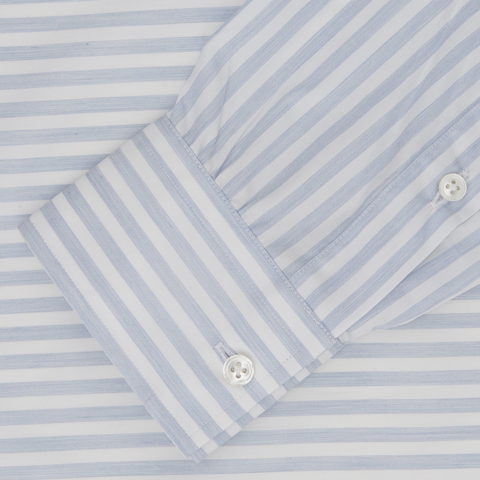 View 2 of product The Turnbull & Asser Weekend Fit Blue Stripe Cotton Shirt with Dorset collar and 1-button cuffs is laid flat on a white background, showcasing its classic long sleeves, striped design, and button-down front.