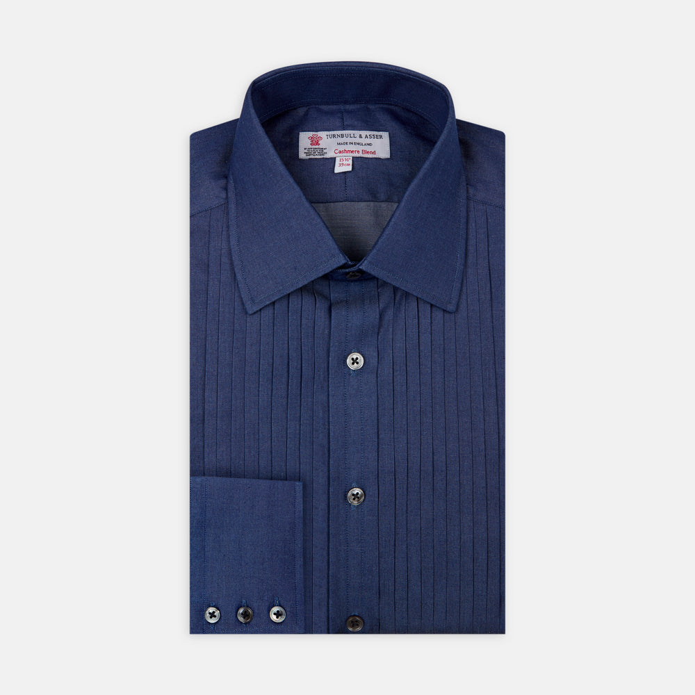 A neatly folded Turnbull & Asser Dark Blue Denim-Cashmere Dress Shirt with T&A collar and 3-button cuffs, showcased on a plain light background, offers a refined formal alternative.