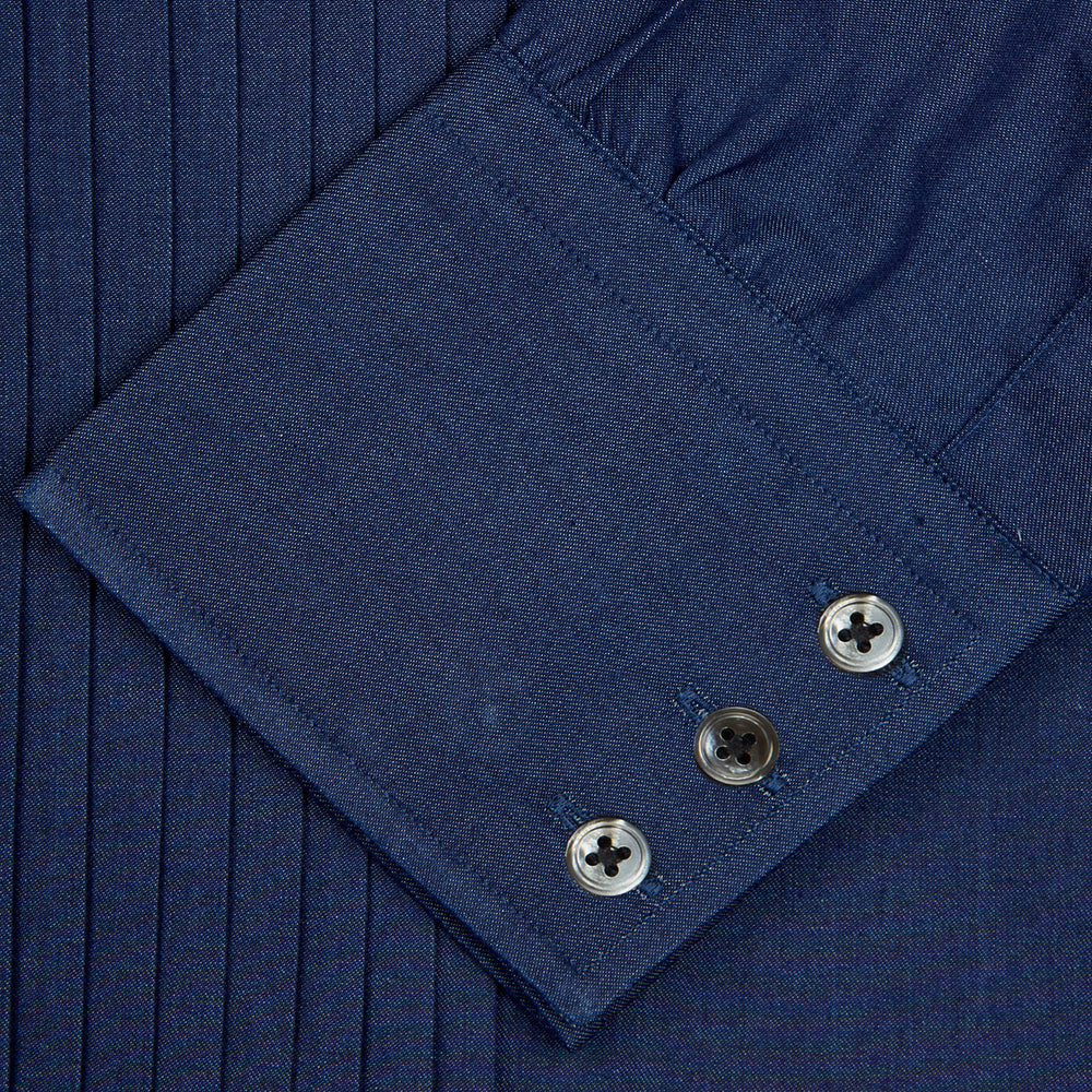 A neatly folded Turnbull & Asser Dark Blue Denim-Cashmere Dress Shirt with T&A collar and 3-button cuffs, showcased on a plain light background, offers a refined formal alternative.